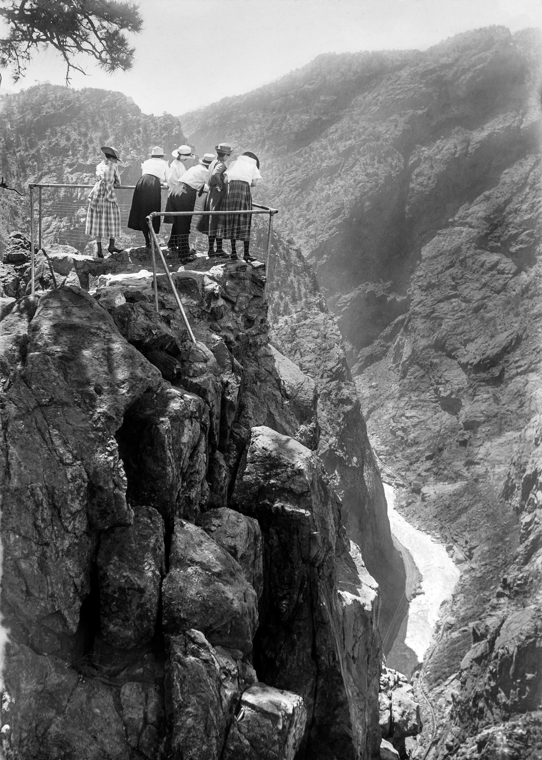 Black and white photo of people standing at overlook of the Royal Gorge. Photo 1918. 2020.014.130