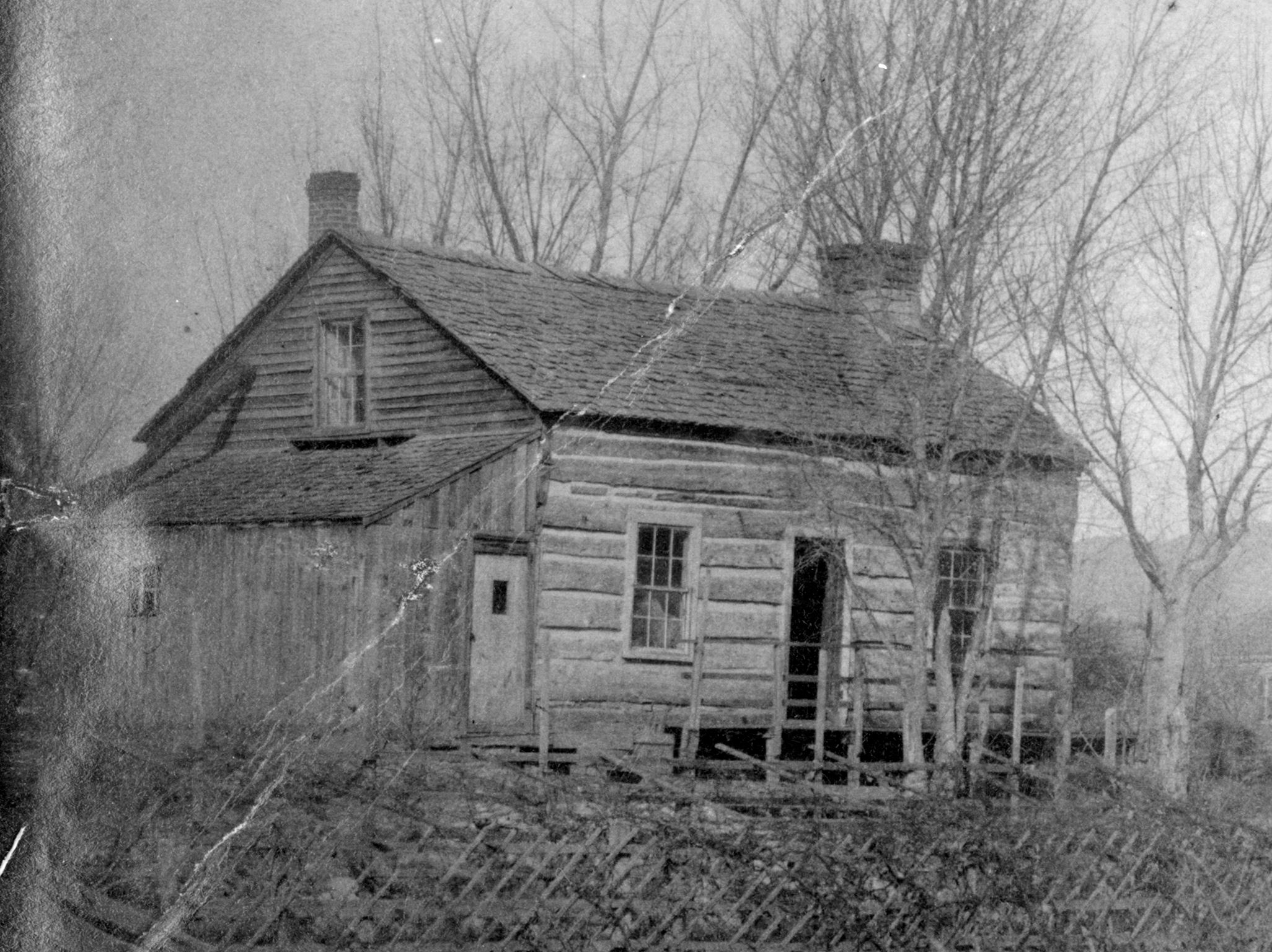 Black and white photo of Anson Rudd log cabin that was built in 1861. Photo circa 1890.