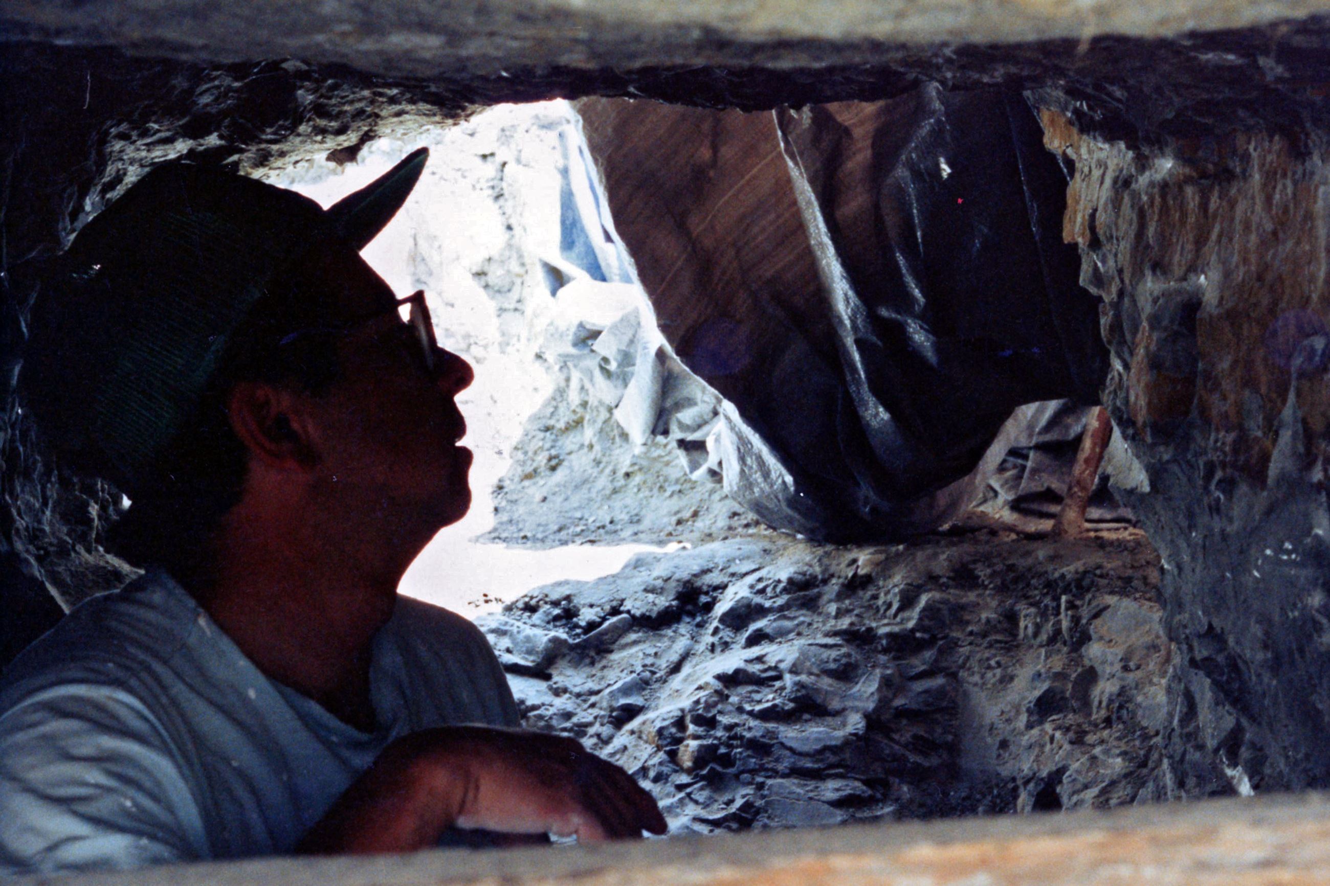 Color photo of Ken Carpenter underneath the Stegosaurus fossil. Circa 1992.